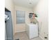 Laundry room with washer, dryer, and shelving at 306 E Dennisport Ct, Gilbert, AZ 85295