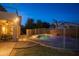 Night view of a kidney-shaped pool with fence at 306 E Dennisport Ct, Gilbert, AZ 85295