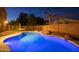 Blue-lit kidney-shaped pool at night at 306 E Dennisport Ct, Gilbert, AZ 85295