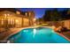 Night view of a pool and home at 306 E Dennisport Ct, Gilbert, AZ 85295