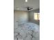 Spacious bedroom with ceiling fan and marble-look floors at 31540 W Maricopa St, Buckeye, AZ 85326