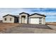 New single-story home with gray exterior, white garage door, and paved driveway at 31540 W Maricopa St, Buckeye, AZ 85326