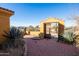 Brick courtyard with a wooden gate leading to a desert landscape at 31617 N 168Th St, Rio Verde, AZ 85263