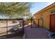 Side view of home with red door and gated dog run at 31617 N 168Th St, Rio Verde, AZ 85263