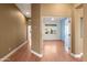 Light-filled hallway with wood flooring, leading to a room with blue accent wall at 31617 N 168Th St, Rio Verde, AZ 85263