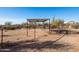 Rustic horse corral with covered shelter and wire fencing at 31617 N 168Th St, Rio Verde, AZ 85263