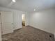 Simple bedroom with carpeted floor and access to bathroom at 318 S Ellsworth Rd, Mesa, AZ 85208