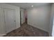 Bright bedroom with carpeted floor and access to hallway at 318 S Ellsworth Rd, Mesa, AZ 85208