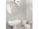 Simple bathroom with pedestal sink and toilet at 3326 E Ivyglen Cir, Mesa, AZ 85213