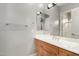 Bathroom with wood vanity, large mirror, and shower at 3326 E Ivyglen Cir, Mesa, AZ 85213