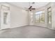 Bright bedroom with large windows and ceiling fan at 3326 E Ivyglen Cir, Mesa, AZ 85213