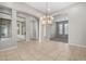 Bright dining room with tile floors and a large chandelier at 3326 E Ivyglen Cir, Mesa, AZ 85213