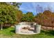 Stone fire pit with built-in seating in a lush garden setting at 3326 E Ivyglen Cir, Mesa, AZ 85213