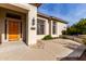 Front entrance with wood door and stone path at 3326 E Ivyglen Cir, Mesa, AZ 85213