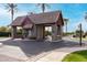 Gated community entrance with guard house and landscaping at 3326 E Ivyglen Cir, Mesa, AZ 85213