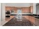 Gourmet kitchen boasting granite countertops and double ovens at 3326 E Ivyglen Cir, Mesa, AZ 85213