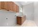 Laundry room with wood cabinets and tile flooring at 3326 E Ivyglen Cir, Mesa, AZ 85213