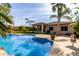 Sparkling blue pool with spacious patio and palm trees at 3326 E Ivyglen Cir, Mesa, AZ 85213