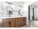 Modern bathroom with double sinks, marble countertops, and arched mirrors at 3390 S Yaqui Ln, Gold Canyon, AZ 85118