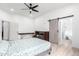 Bedroom with ceiling fan, barn door, and access to bathroom at 3390 S Yaqui Ln, Gold Canyon, AZ 85118