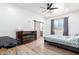 Bright bedroom with a ceiling fan, fireplace, and barn door at 3390 S Yaqui Ln, Gold Canyon, AZ 85118