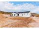 View of a single story house with white exterior, dark gray roof, and mountain views at 3390 S Yaqui Ln, Gold Canyon, AZ 85118