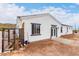 White house exterior with dark gray accents, featuring a fenced backyard at 3390 S Yaqui Ln, Gold Canyon, AZ 85118