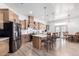 Open concept kitchen with island, stainless steel appliances, and light wood cabinets at 3390 S Yaqui Ln, Gold Canyon, AZ 85118