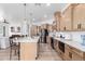 Modern kitchen with large island, stainless steel appliances, and light wood cabinets at 3390 S Yaqui Ln, Gold Canyon, AZ 85118