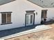 Newly built patio with gray pavers, set off the back of this stucco home with black trim and white French doors at 3390 S Yaqui Ln, Gold Canyon, AZ 85118