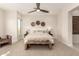 Serene bedroom with a ceiling fan, neutral decor, plush carpet, and an abundance of natural light at 37178 N Winding Wash Trl, Carefree, AZ 85377