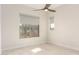 Well-lit bedroom features neutral walls, tile flooring, and a ceiling fan for added comfort at 37178 N Winding Wash Trl, Carefree, AZ 85377