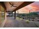 Scenic covered patio with ceiling fan, and desert landscape at sunset at 37178 N Winding Wash Trl, Carefree, AZ 85377