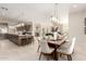 Dining room showcases an elegant pendant light fixture above the dining table, adjacent to a kitchen with a large island at 37178 N Winding Wash Trl, Carefree, AZ 85377