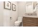 Stylish powder room features geometric wallpaper, a floating vanity, and elegant fixtures at 37178 N Winding Wash Trl, Carefree, AZ 85377