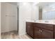 Bathroom with double vanity, wood cabinets, and a shower/tub combo at 3818 S 84Th Ln, Tolleson, AZ 85353