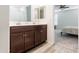 Double sink bathroom with wood cabinets and a view of a bedroom at 3818 S 84Th Ln, Tolleson, AZ 85353