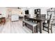 Modern dining room with a wood table and gray upholstered bench at 3818 S 84Th Ln, Tolleson, AZ 85353