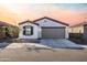 One-story home with gray garage door and front landscaping at 3818 S 84Th Ln, Tolleson, AZ 85353