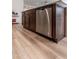 Kitchen island with stainless steel dishwasher and wood cabinets at 3818 S 84Th Ln, Tolleson, AZ 85353