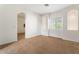 Bright bedroom with neutral carpeting and an arched doorway at 3935 E Rough Rider Rd # 1270, Phoenix, AZ 85050