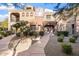 Two-story stucco home with Spanish-style architecture,landscaped yard, and walkway at 3935 E Rough Rider Rd # 1270, Phoenix, AZ 85050