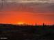 Stunning sunset view over desert landscape with distant mountains and homes at 4028 N Ranier --, Mesa, AZ 85215