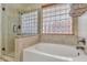 Bathroom with soaking tub, walk-in shower, and large window with blinds at 4028 N Ranier --, Mesa, AZ 85215