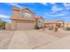 Two-story house with a tan exterior, landscaped yard, and two-car garage at 4028 N Ranier --, Mesa, AZ 85215