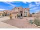 Two-story house with a tan exterior, landscaped yard, and two-car garage at 4028 N Ranier --, Mesa, AZ 85215