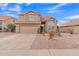 Two-story house with a tan exterior, landscaped yard, and two-car garage at 4028 N Ranier --, Mesa, AZ 85215