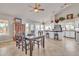 Open concept kitchen and dining area with island and wooden table at 4028 N Ranier --, Mesa, AZ 85215