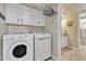 Bright laundry room with washer, dryer, and ample cabinet space at 4028 N Ranier --, Mesa, AZ 85215