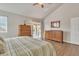 Main bedroom with wood floors, striped bedding, and sliding door to patio at 4028 N Ranier --, Mesa, AZ 85215